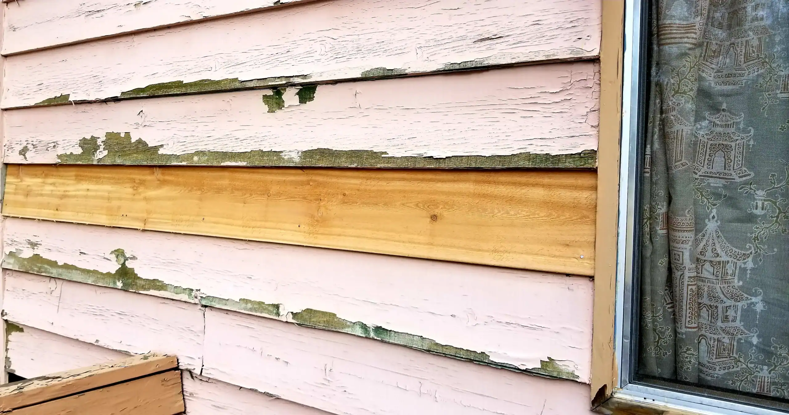 Torn-up home siding that needs repair. Home siding repairs in Greenwood, SC