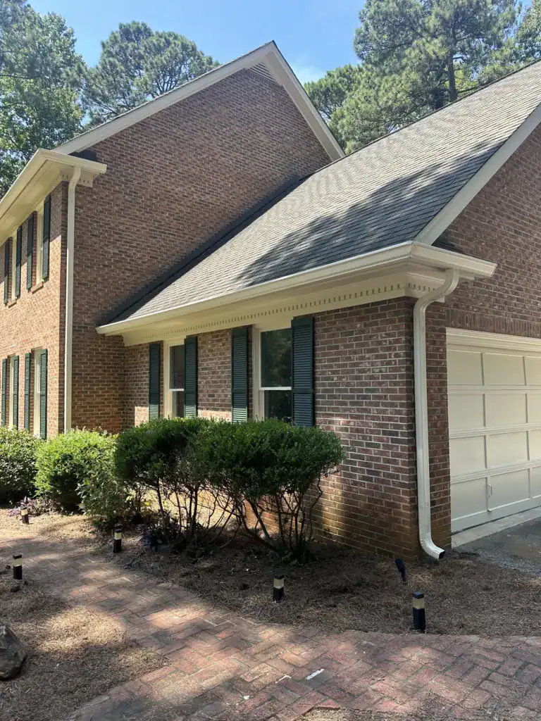 Beautiful brick house with landscaped garden and clean driveway.