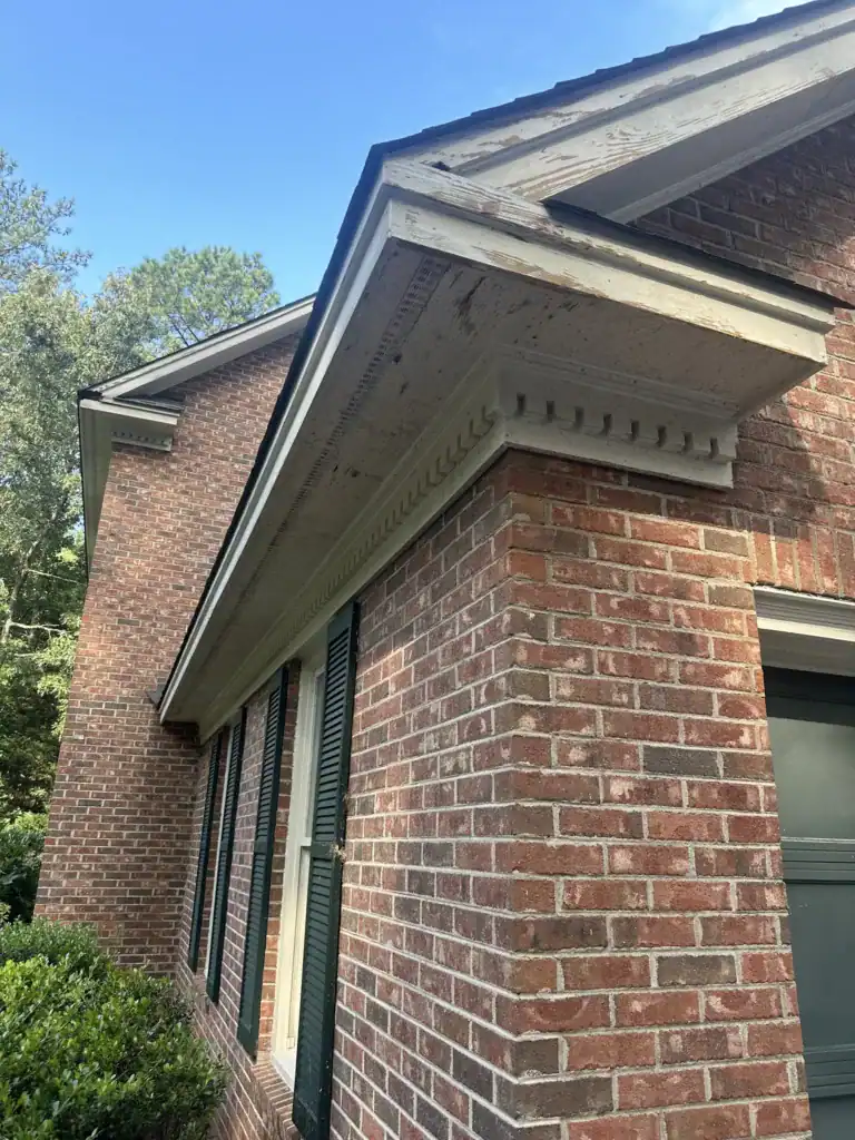 Close-up of house soffit and fascia with brick exterior.