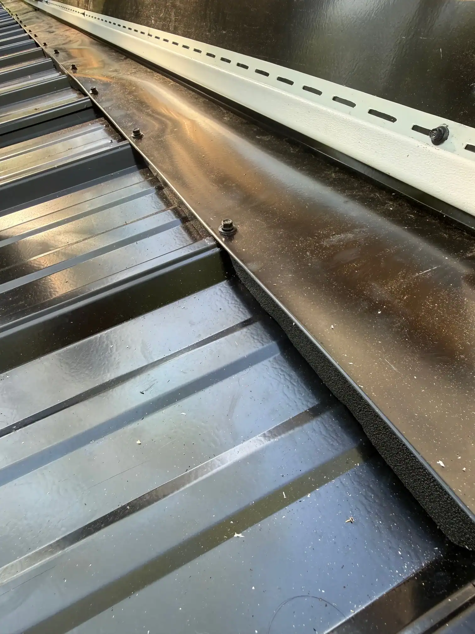 Sealed metal roof seam showing waterproofing application for roof protection.