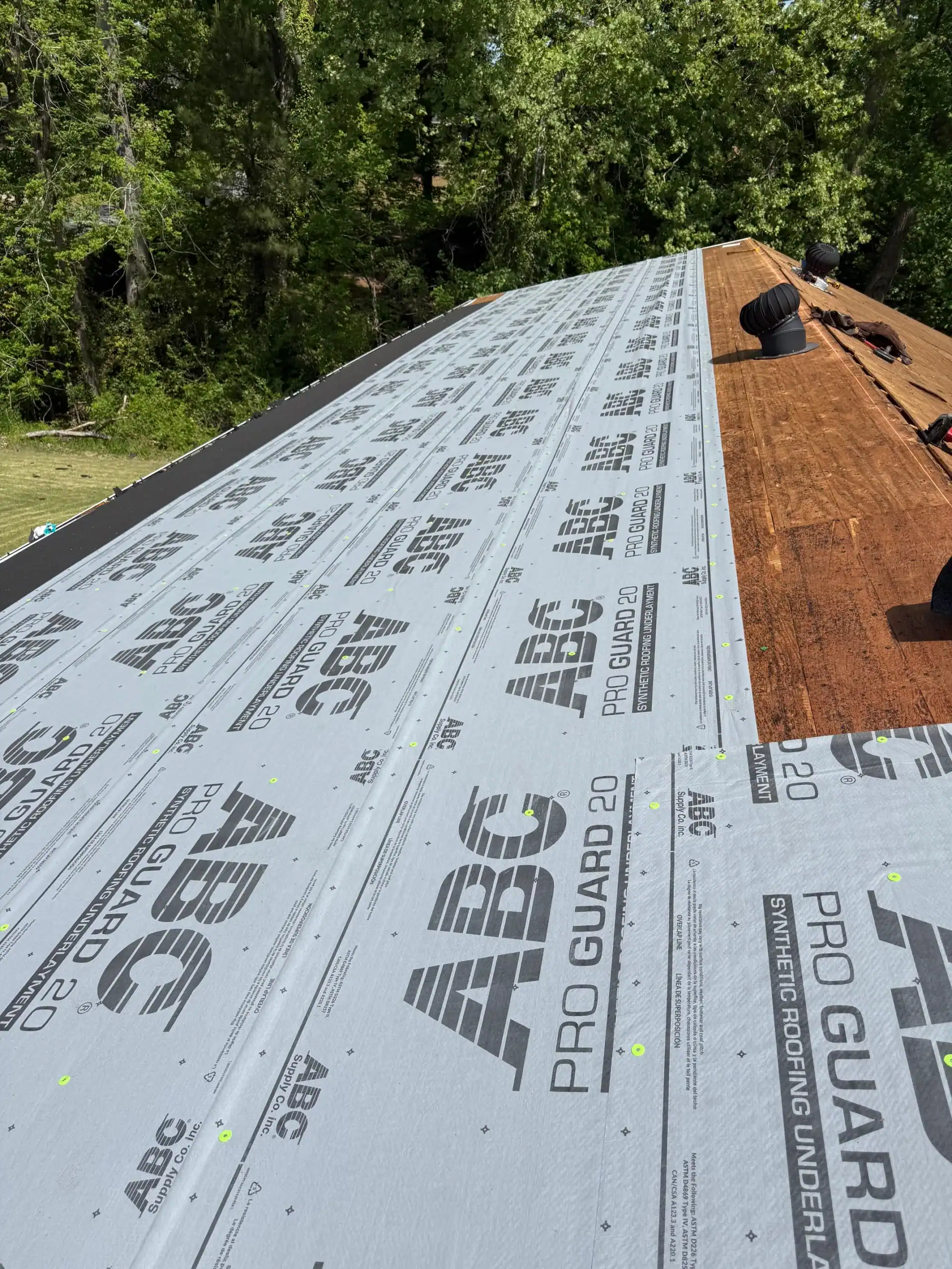 Roofing underlayment with ABC PRO GUARD installed on the roof surface.